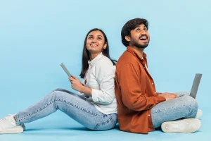 two people happy to get laptops on loan as device lock technology enabled lenders