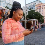medium-shot-woman-using-smartphone-outdoors